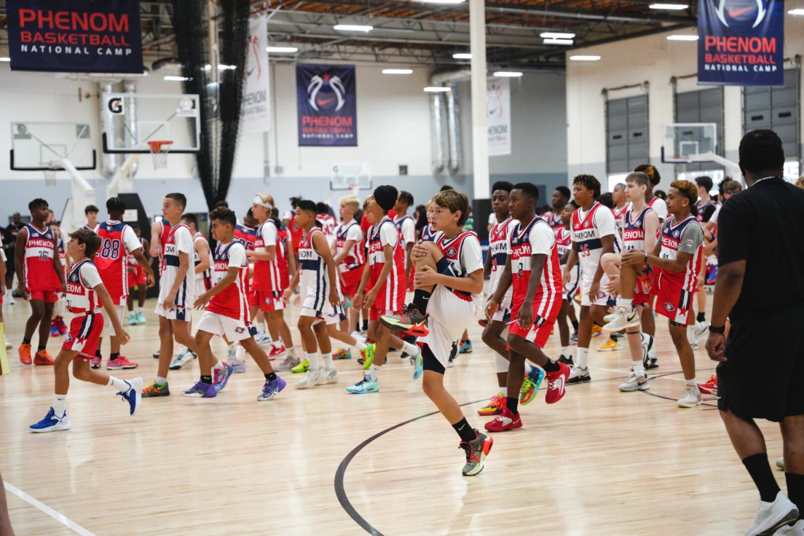 Youth basketball players walk on court during a game.