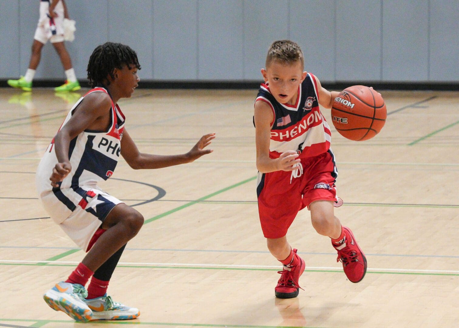 Two small children running with basket ball in hand
