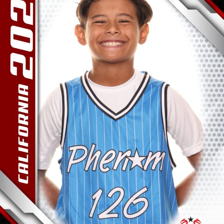 Young basketball player in a blue jersey smiling confidently.