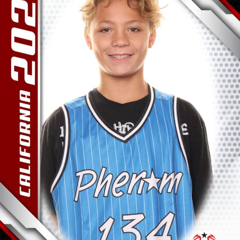 Youth basketball player in a blue Phenom jersey smiling.