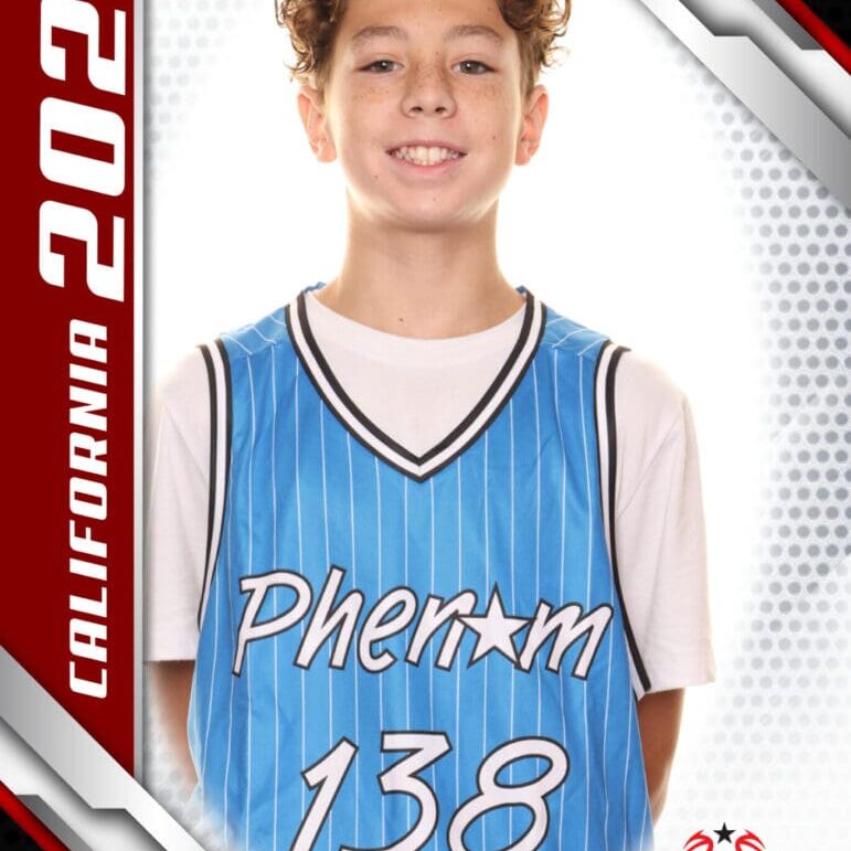 Young basketball player in a blue jersey smiling for a portrait.
