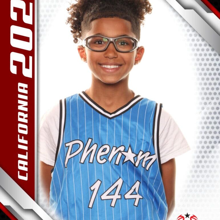 Young basketball player in a blue jersey smiling confidently.