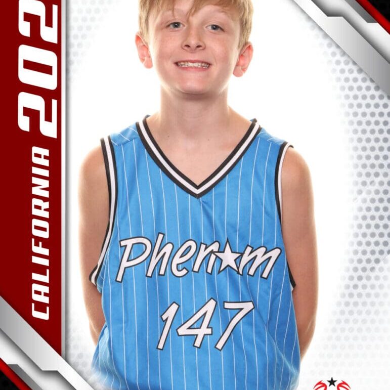 A young basketball player in a blue Phenom 147 jersey posing for a sports photo.
