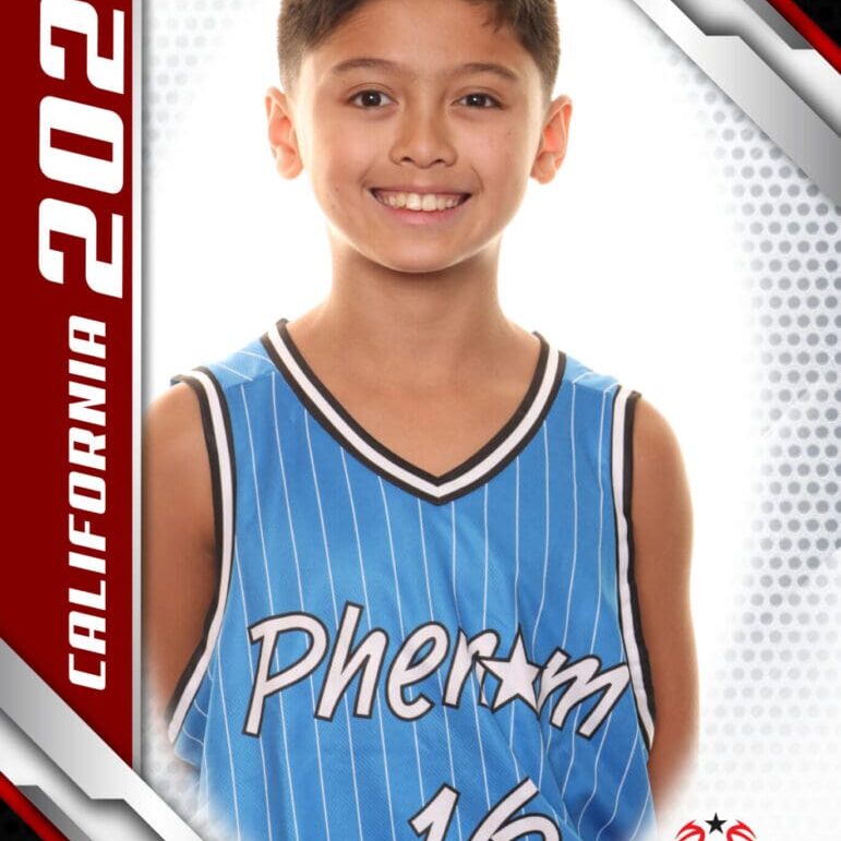 Young basketball player smiling in blue jersey.