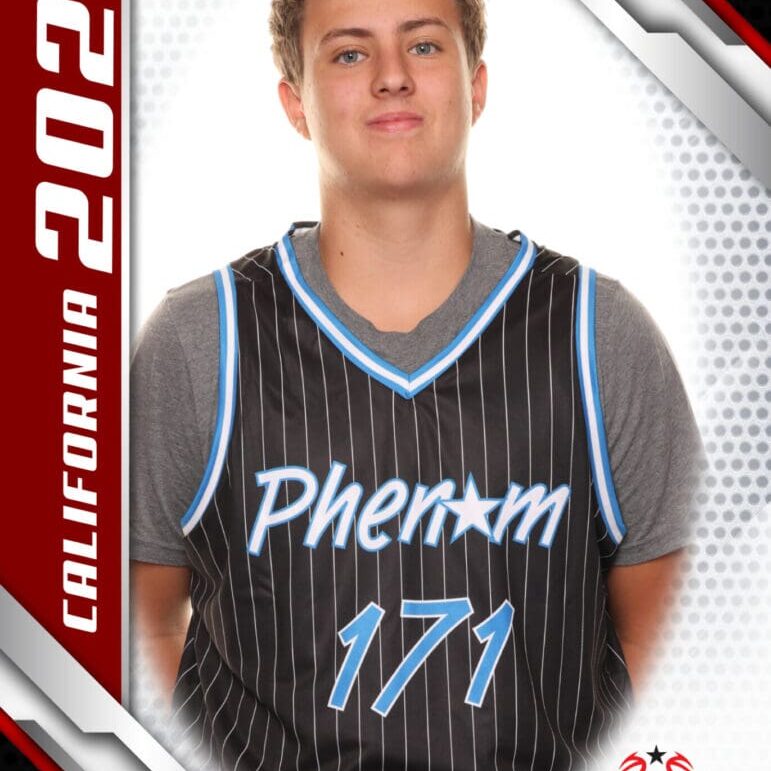 Young male basketball player in a black Phenom jersey posing for a sports photo.