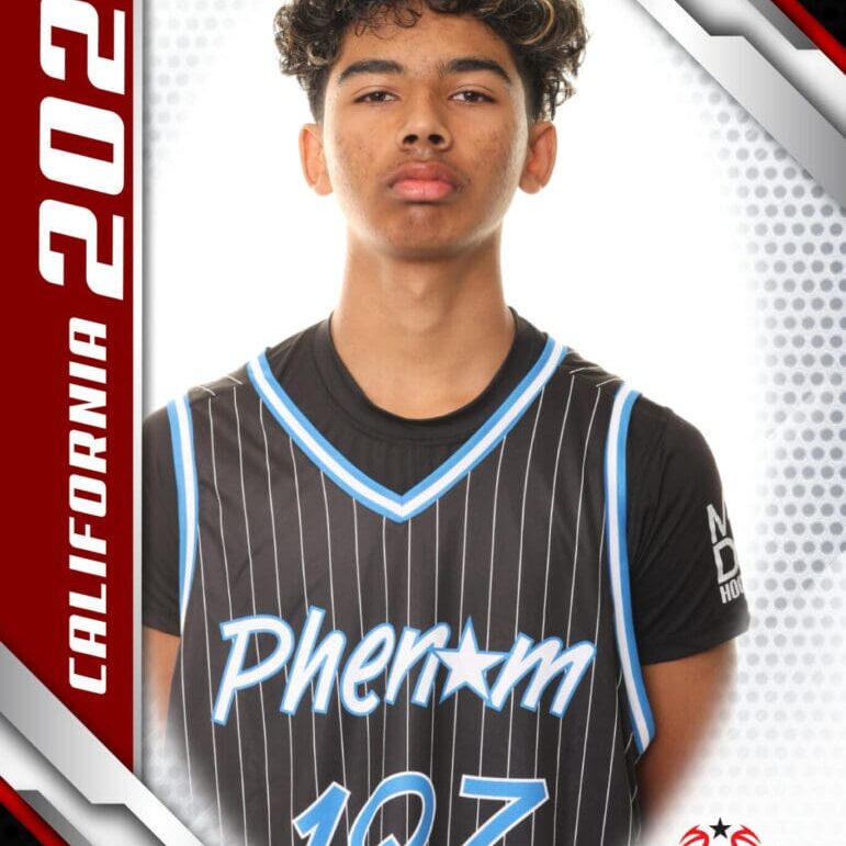 Young basketball player in a Phenom jersey posing for a portrait.