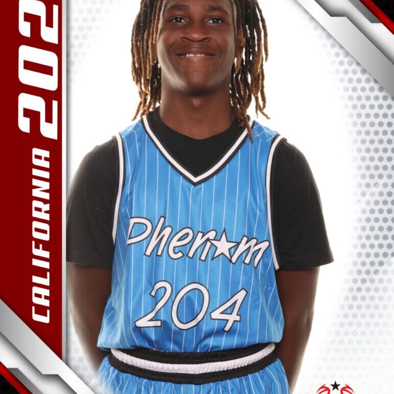 Young basketball player in blue jersey smiling for a portrait.