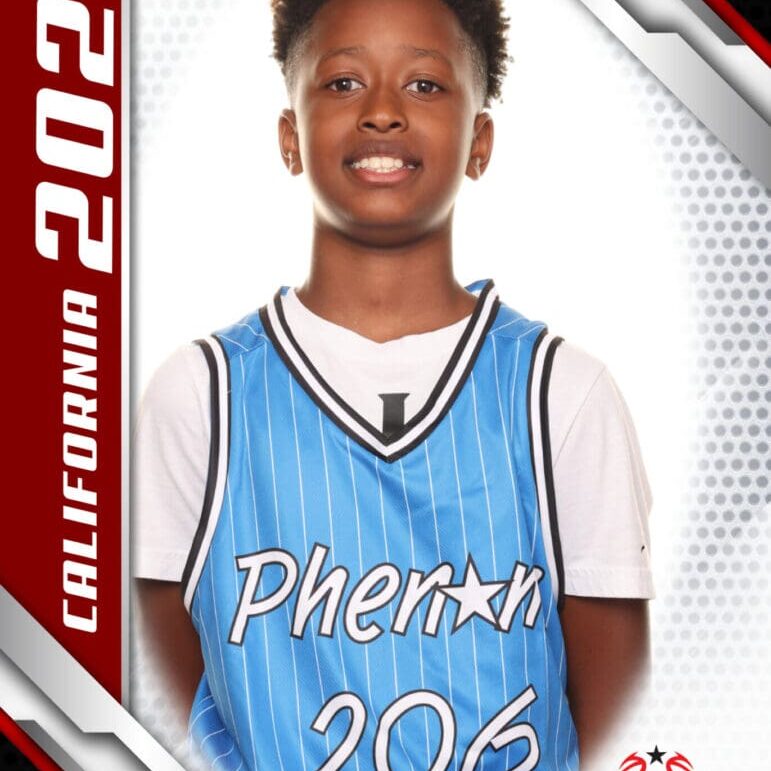 Young basketball player in a blue jersey smiling for a portrait.