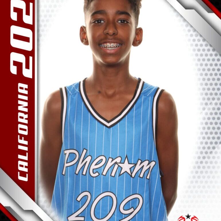 Young basketball player in a blue jersey smiling for a portrait.