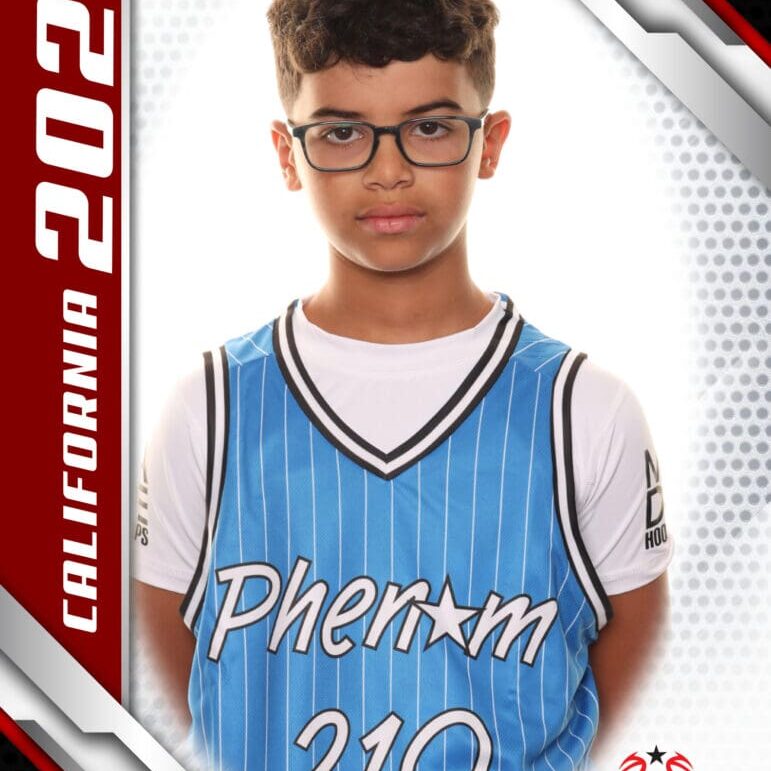 Young boy in a basketball jersey posing for a photo.