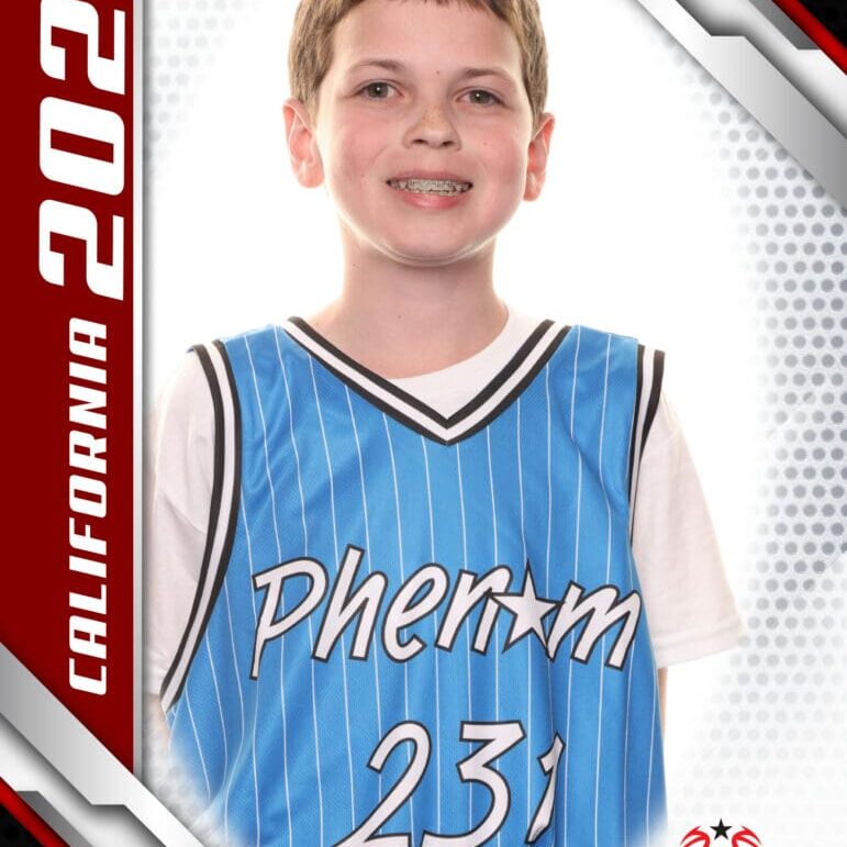 Young basketball player in a blue jersey smiling for a portrait.