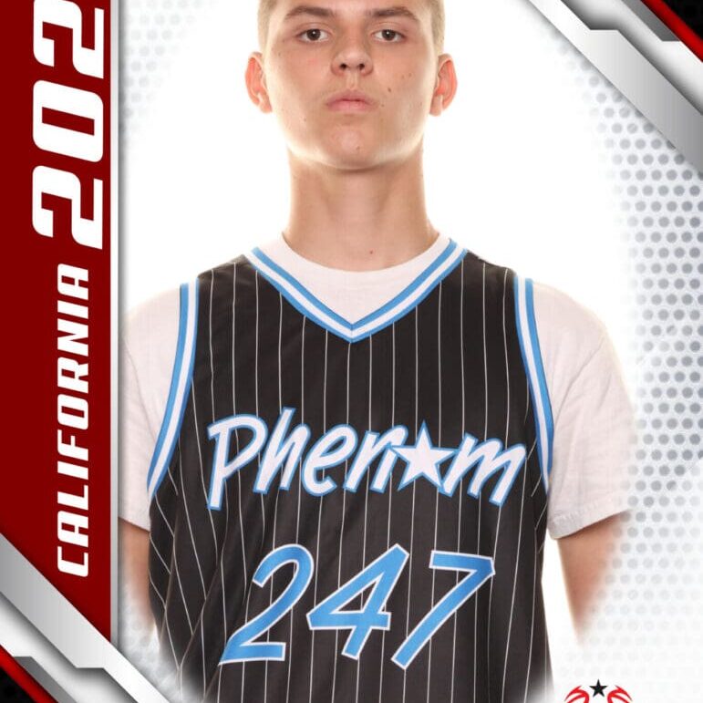 Young basketball player in a Phenom 247 jersey posing for a portrait.