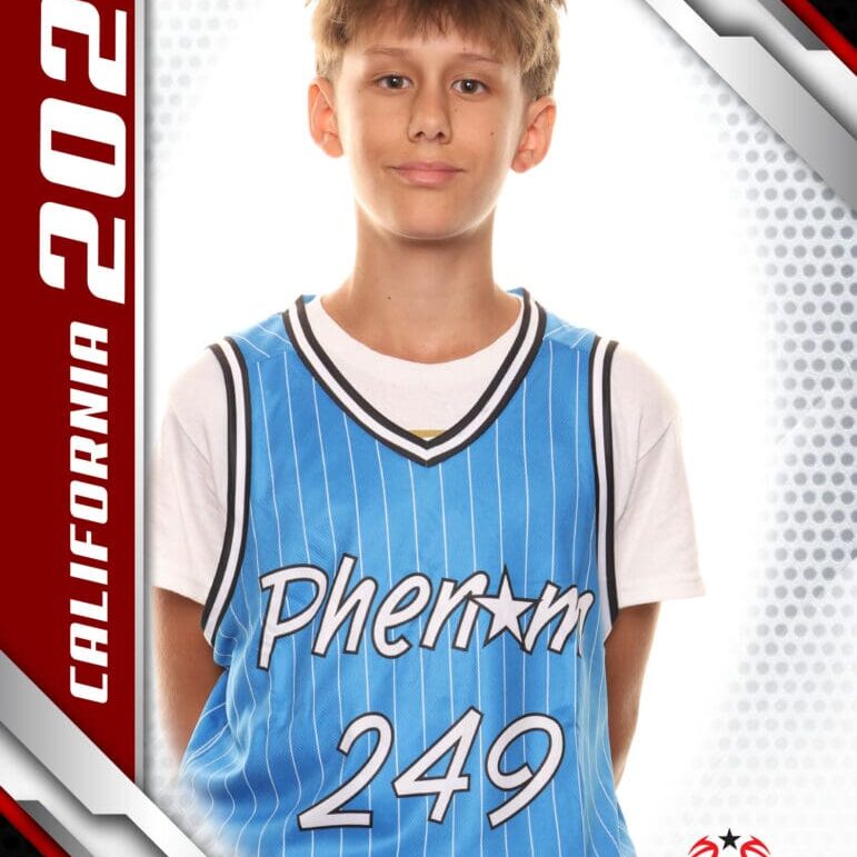 Young basketball player in a blue jersey posing for a photo.