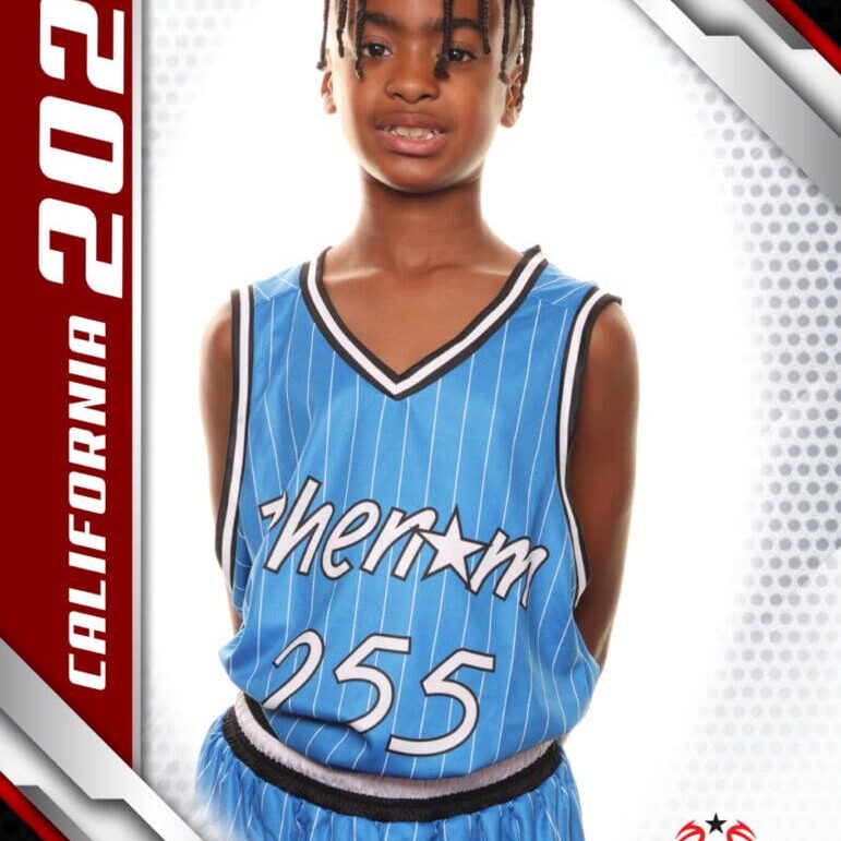 Young basketball player in a blue jersey posing for a portrait.