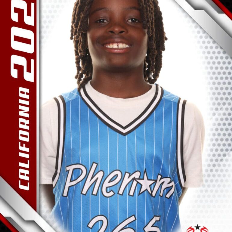 Young basketball player in blue jersey smiling at the camera.