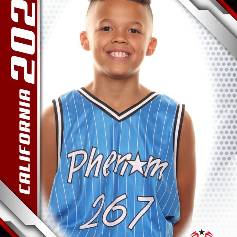 Young basketball player in a blue Phenom 167 jersey smiling for a photo.
