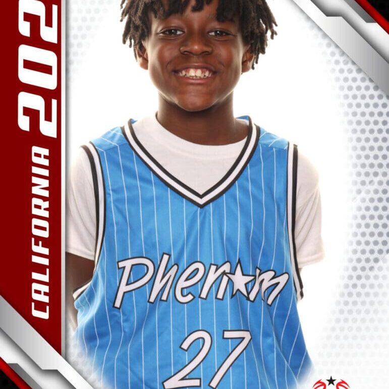 Young basketball player in blue jersey smiling for a portrait.