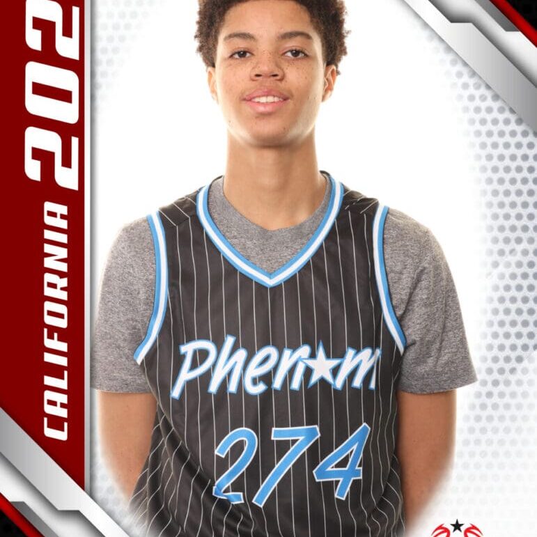 Young basketball player in a Phenom jersey posing for a photo.
