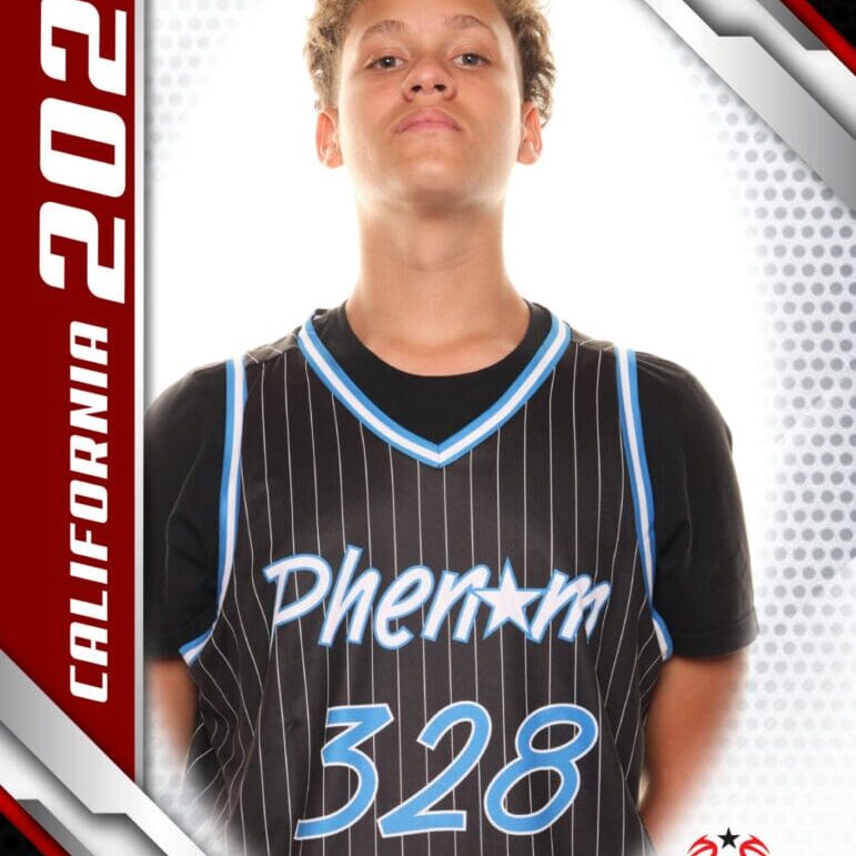Young basketball player in a Phenom 328 jersey poses confidently.