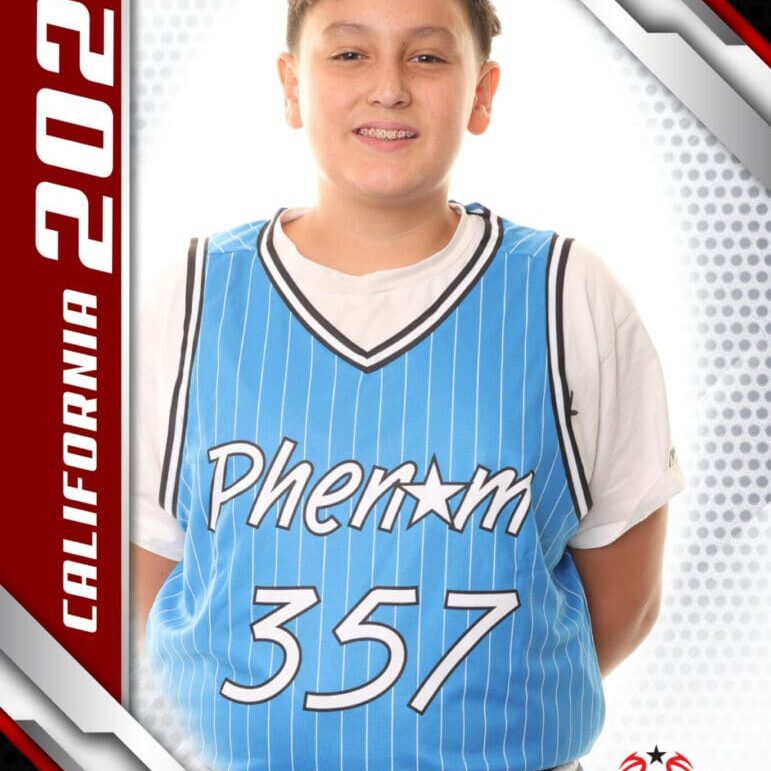 Young boy smiling in a blue basketball jersey.