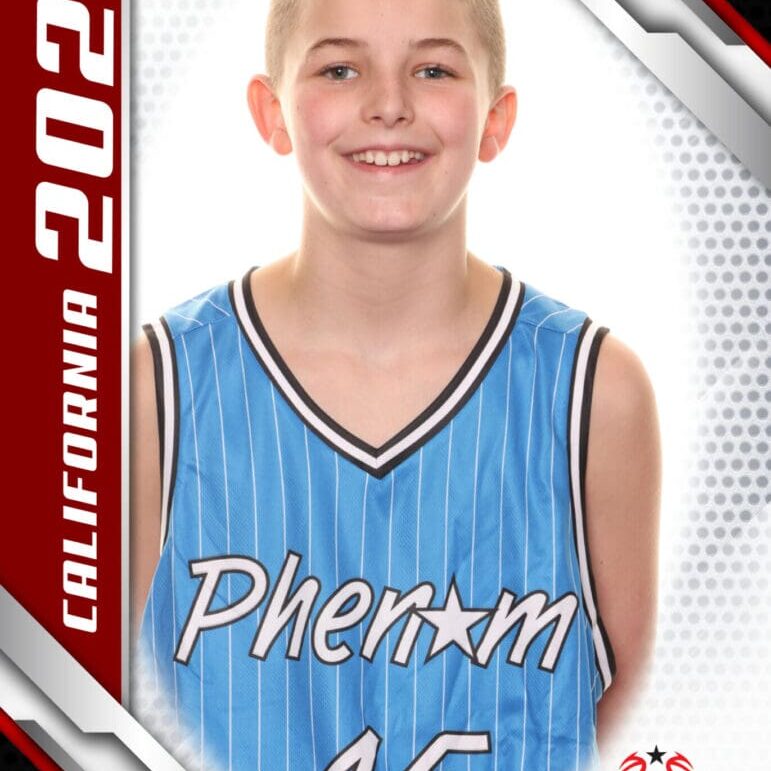 Young basketball player in a blue Phenom jersey smiling for a portrait.