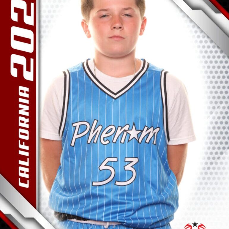 Young basketball player in a blue Phenom jersey posing for a photo.