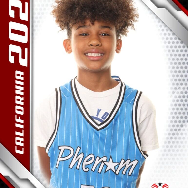 Young basketball player in a Phenom jersey smiles for a portrait.