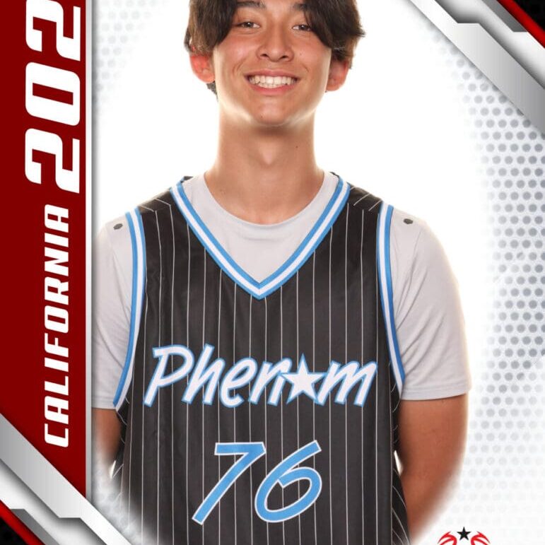 Young athlete in a basketball jersey smiling for a photo.