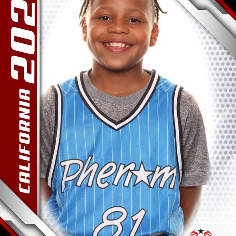 Smiling young boy in a blue basketball jersey posing for a photo.